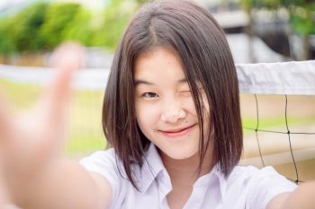 Cute asian student girl winking eye smiling expression selfie camera, close-up shot