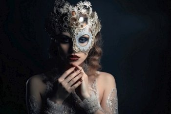 A beautiful woman in an elegant dress with a Venetian carnival mask created with generative AI technology