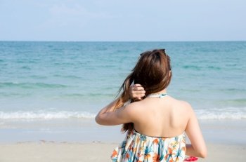 asian women portrait touch her hair on beach