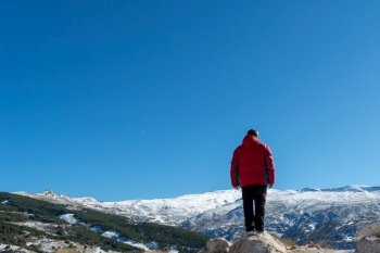 Man standing on the edge of a cliff and contemplating nature’s creation in sierra nevada,. Man standing on the edge of a cliff and contemplating nature’s creation in sierra nevada