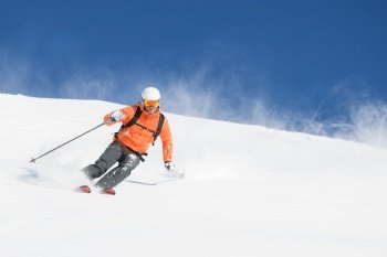 Mountaineering skier during powder descent