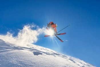 A boy performs an off-piste ski jump