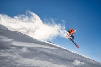 A young skier in the sky during a jump