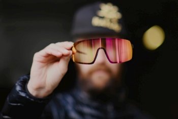 A man with a beard shows glasses lenses
