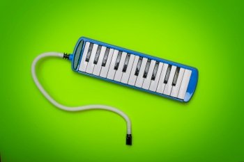 Wind instrument with keyboard la melodica on a colorful background