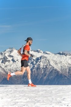 A man mountain runner trains in the snow at high altitude