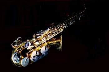 Saxophone musical instrument on a black background