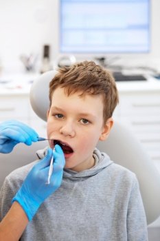 Kid in a dental clinic. Orthodontic treatment. Children’s dentistry, Pediatric Dentistry. A boy in braces on his teeth at a dentist’s appointment. Oral health and hygiene. 