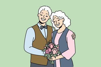 Elderly couple in love smiles rejoicing at happy family life, poses for picture on eve of golden wedding. Elderly family of man and woman hugging each other, looking at screen and laughing. Elderly couple in love smiles rejoicing at happy family life and poses for picture to golden wedding