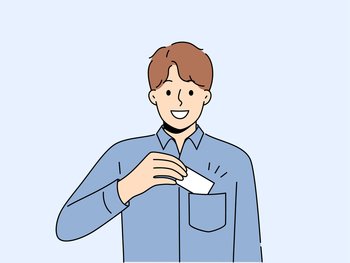 Man takes out business card from pocket to exchange contacts with potential partner or buyer and looks into camera with smile. Business guy in blue shirt wants to share contacts with new acquaintances. Man takes out business card from pocket to exchange contacts with potential partner or buyer