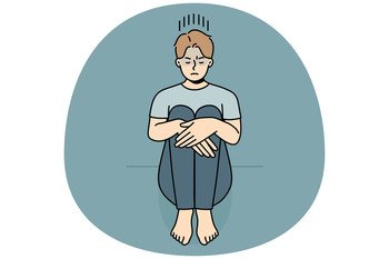 Unhappy young man sitting on floor suffer from loneliness or depression. Upset sad guy struggle from solitude or bad mood. Vector illustration.. Unhappy man suffer from loneliness