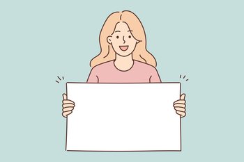 Positive woman holding blank white placard smiling and looking at camera demonstrating banner with copy space. Young girl teenager shows blank banner for presentation of promotional product . Woman holding blank white placard smiling and looking at camera demonstrating banner with copy space