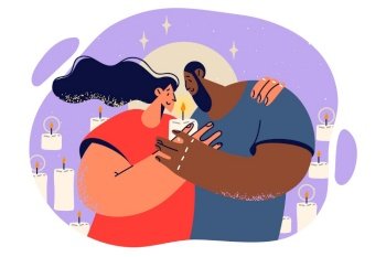 Happy couple hugging and holding burning candle spending romantic evening together for concept diversity and multiracial love. Multiracial young family enjoys privacy and intimacy.. Happy couple hugging and holding burning candle spending romantic evening together.