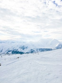View of snowcapped mountains. Ski resort. Winter sport. Snowy mountains of Gudauri Georgia. View of snowcapped mountains. Ski resort
