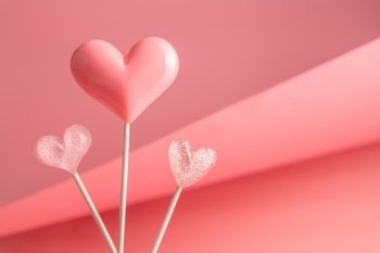 three Pink Valentine’s day heart shape lollipop candy on empty pastel pink background. Love Concept. Minimalism colorful style. with copy space. three Pink Valentine’s day heart shape lollipop candy on empty pastel paper background. Love Concept