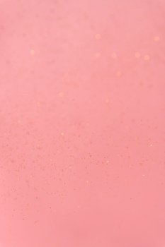 pink abstract background with flying gold sequins