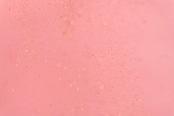pink abstract background with flying gold sequins