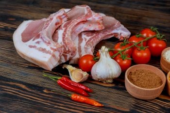 Raw pork steak - ready for cooking with herbs. Gray background Raw pork steaks on wooden board with spice. Screen display of cryptocurrency mining Dual mining Gold Bitcoin cryptocurrency mining