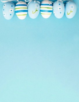 easter colorful handmade painted eggs on blue background with copy space.. easter colorful handmade painted eggs on blue background with copy space. banner