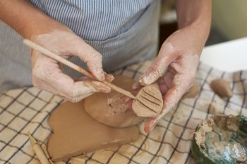woman forming clay pot shape by hands, closeup in artistic studio.. woman forming clay pot shape by hands, closeup in artistic studio