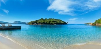 Beautiful Ionian Sea with clear turquoise water and morning summer coast. View from Ksamil beach, Albania.Three shots stitch panorama.