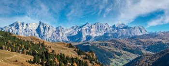 Autumn alpine Dolomites mountain scene, Sudtirol, Italy. Peaceful view near Gardena Pass. Picturesque traveling, seasonal, nature and countryside beauty concept scene.