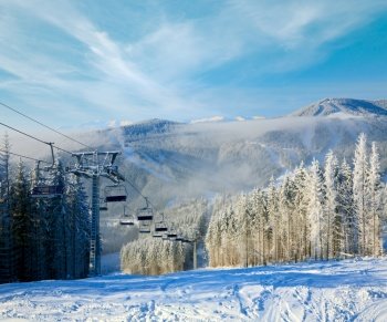 winter mountain landscape with ski lift and skiing slope