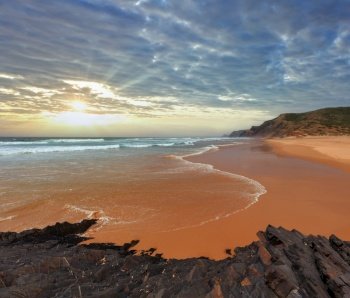 Storm on Castelejo beach with black schist cliffs (Algarve, Portugal). Peoples unrecognizable.