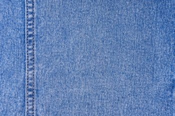 Denim jeans texture background. Texture of blue colored cotton fabric with decorative seam. Stiched texture jean background. Fiber and fabric structurel. Wallpaper, banner, backdrop, header. Blue denim jeans with a seam texture background