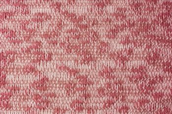 Close up background of knitted wool fabric made of viscose yarn. Mix of red and white color, melange wool knitwear texture. Abstract knitted jersey background. Fabric abstract backdrop, wallpaper. Bright red white melange knitwear wool fabric texture background. Abstract textile backdrop