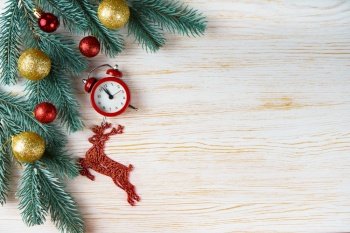 Decorated Christmas and New Year tree, toy deer and clock on white wooden background with copy space. Top view, flatlay.. Christmas tree on white wooden background vintage frame.