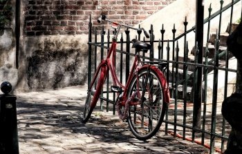 bicycle red wheel fence alley