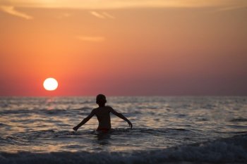 beach boy sunset silhouette