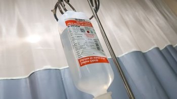 Hanging pillar and Saline solution fluid iv bag in emergency room at hospital in indonesia