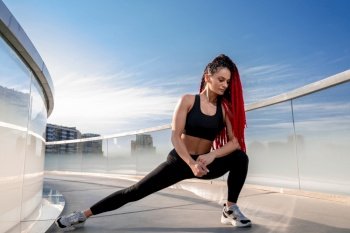 Fitness, exercise and a woman stretching at gym during warm up workout and training for health and wellness. Sports female or athlete on ground to stretch legs to be flexible, balance and healthy