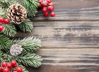Christmas background with fir tree and decor on old wooden background background. Top view with copy space