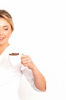 Cup of coffee beans. The female nutritionist holds a cup of coffee beans in her hand on white background. Cup of coffee beans. The female nutritionist holds a cup of coffee beans in her hand on white background.