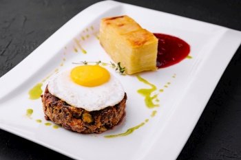 fried vegetable tartare with egg on plate