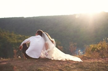 wedding couple in love sitting together and enjoying the view