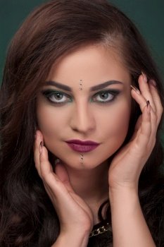 Close-up portrait, girl with green eye shadows, make-up, facial stones crystals