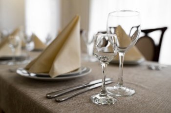 empty goblets and other cutlery are served on the festive table