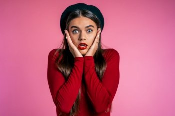 Portrait of cute girl shocked. Pretty woman with perfect make-up, stylish outfit surprised to camera over pink background. Portrait of cute girl shocked. Pretty woman with perfect make-up