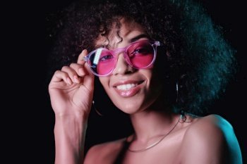 Alluring unusual girl with curly afro hair corrects her glasses. Sexy woman with perfect makeup looking at camera and smiling. Glamour, fashion concept. Alluring unusual girl with curly afro hair corrects her glasses. Sexy woman with perfect makeup looking at camera and smiling. Glamour, fashion concept.