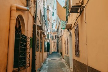 Beautiful cozy narrow street in old town of Italy or Greece. Historic european facades of buildings. Cityscape concept. High quality photo. Beautiful cozy narrow street in old town of Italy or Greece. Historic european facades of buildings. Cityscape concept.