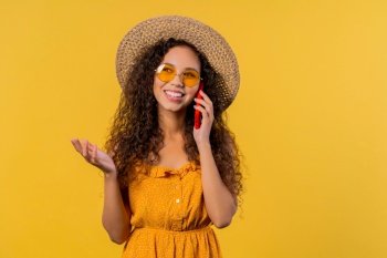 Attractive woman talking by phone, nice joke, smiling. Young lady on yellow background. Having smartphone call. High quality photo. Attractive woman talking by phone, smiling. Young lady on yellow background.