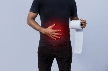 People with stomach problems holding toilet paper, Person with toilet paper with stomach problems on isolated background, Concept of a person with digestive problems