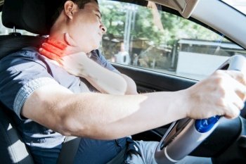 A driver with neck pain, concept of a man in his car with neck pain. An exhausted driver with neck pain in traffic, A person with neck pain in traffic
