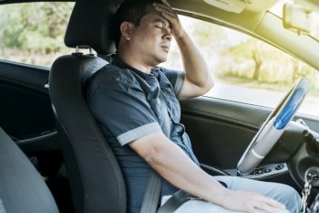 A person in his car with a headache, Concept of a man in his car with a headache, A car driver with a headache, A driver with stress and migraine