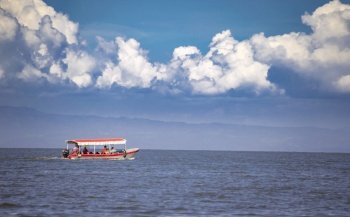 People sailing in a boat on Lake Nicaragua, a boat with people wearing life jackets.