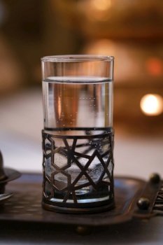 Water in a glass in Turkish style. Atmospheric photo from the cafe.. Water in a glass in Turkish style.